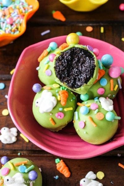 chocolate cake pops coated in green candy melts with easter sprinkles