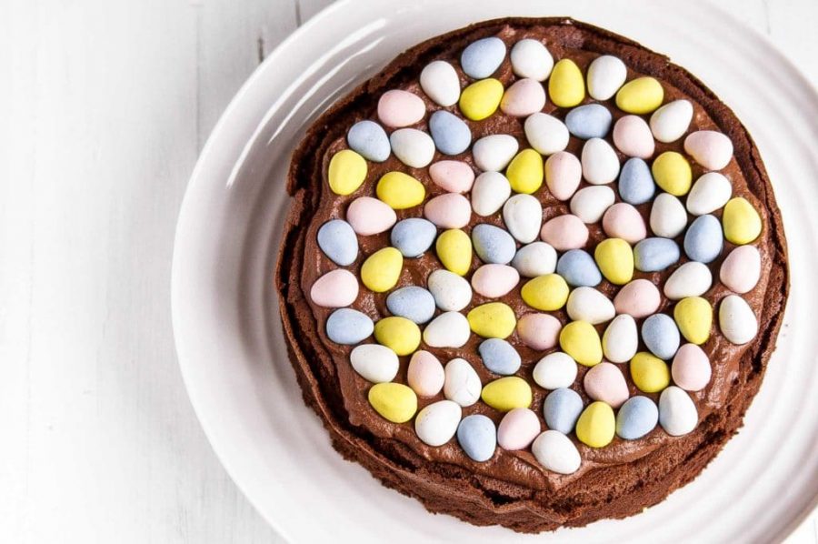 chocolate cake topped with chocolate cream and colored chocolate easter eggs