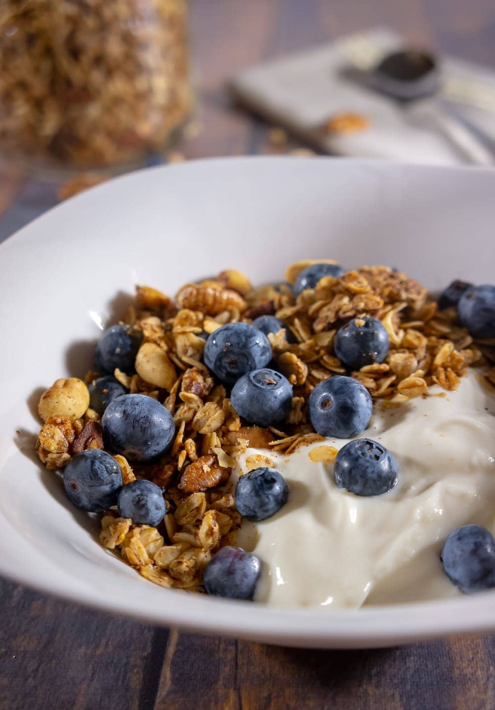 A bowl of homemade granola on yogurt with blueberries